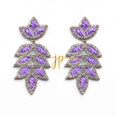 A pair of earrings with purple and silver leaf-shaped designs, featuring a combination of embroidered and metallic elements.